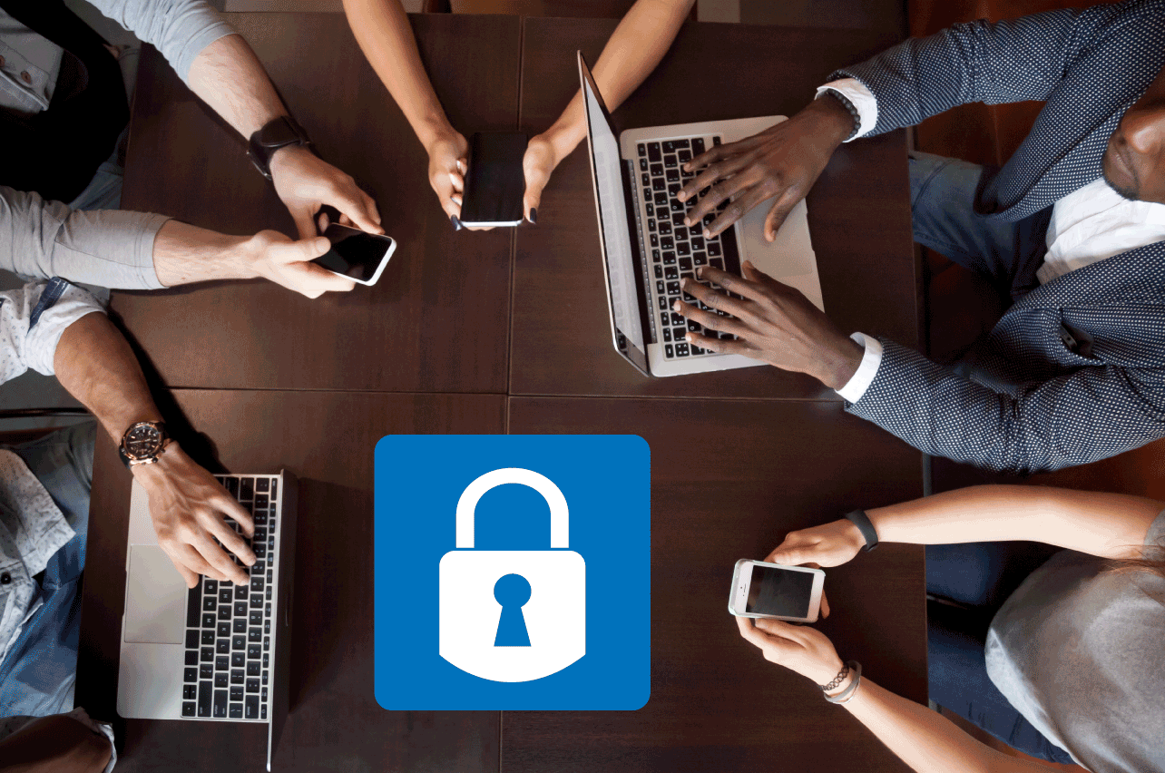 Group of people in a circle on their phones and laptops with a blue padlock icon in the middle of the table